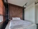 bedroom with wooden accent wall and platform bed