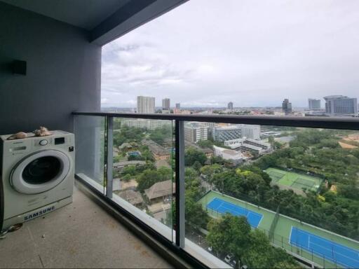 Balcony with scenic city view and washing machine