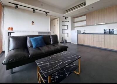 Modern living room with black sofa and marble coffee table