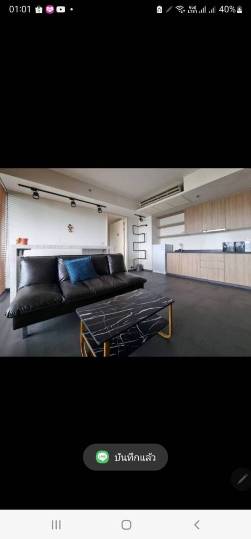 Modern living room with black sofa and marble coffee table