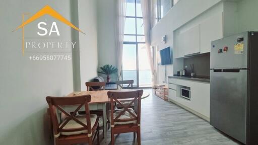 Modern kitchen and dining area with appliances and dining table