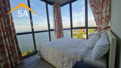 Bedroom with large windows and sea view