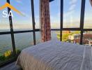 Bedroom with large windows and scenic water view