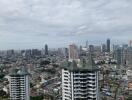 Cityscape view with high-rise buildings and a cloudy sky.