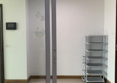 Empty main living area with a sliding glass door and a shelf