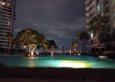 Swimming pool area at night with city view