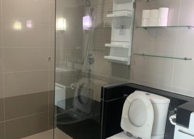 Modern bathroom with glass-enclosed shower and toilet