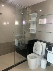 Modern bathroom with glass-enclosed shower and toilet