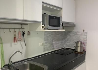 Modern kitchen with white cabinetry and black countertop