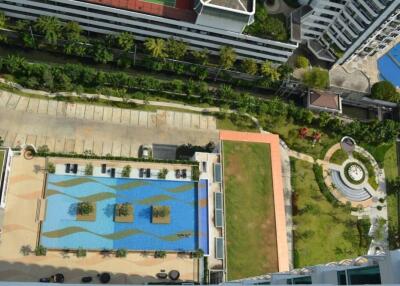 Overhead view of apartment complex with swimming pool and greenery