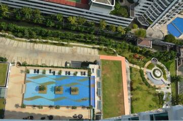 Overhead view of apartment complex with swimming pool and greenery