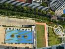 Overhead view of apartment complex with swimming pool and greenery