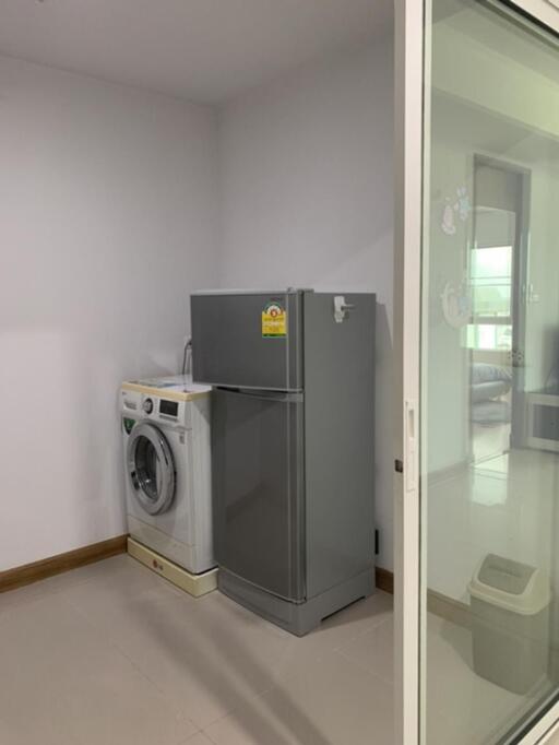 Modern laundry area with washing machine and refrigerator