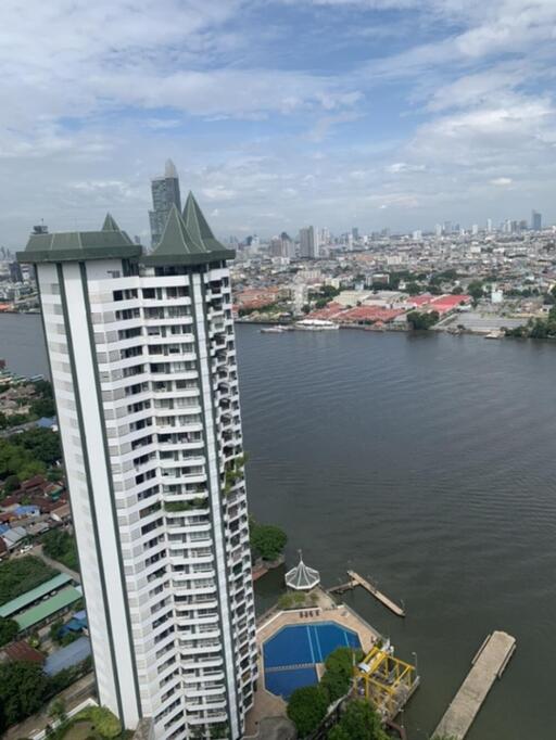 High-rise residential building with a river view and swimming pool