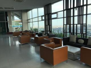 Modern lounge area with seating and large windows