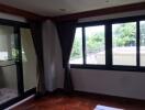 Spacious bedroom with large windows and balcony access