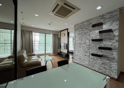 Modern living room with wall-mounted shelves and large windows