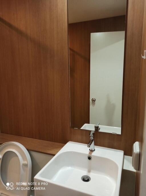 Modern bathroom with sink, mirror, and toilet