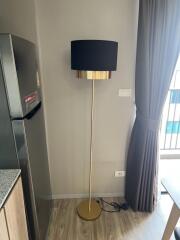 Modern living area with a floor lamp and refrigerator