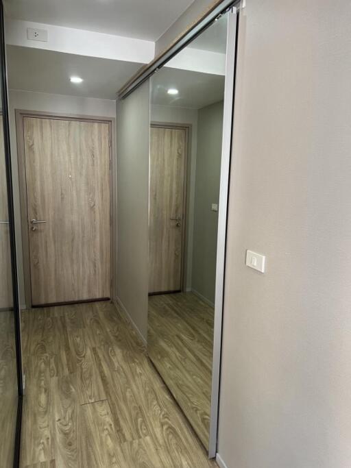 Hallway with wooden floor and large mirror