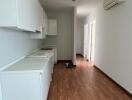 Modern kitchen with white cabinets and wooden floor