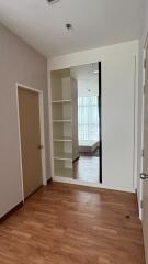 Empty bedroom with built-in shelving and large window