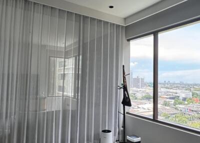 Modern bedroom with large window and city view