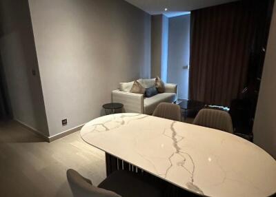 Living area with a modern sofa and a marble dining table