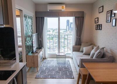 Modern living room with view, adjacent to small bedroom