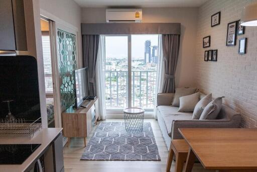 Modern living room with view, adjacent to small bedroom