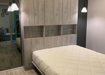 Modern bedroom with built-in closet and pendant lighting