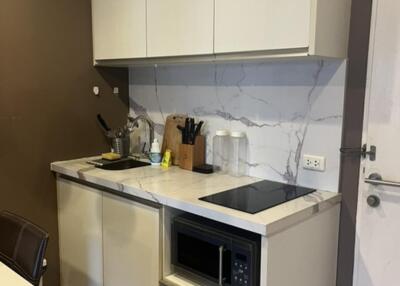 Modern small kitchen with a microwave and stovetop