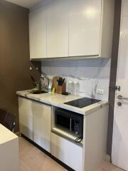 Modern small kitchen with a microwave and stovetop