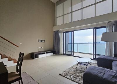 Modern living room with large windows and sea view