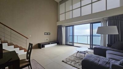 Modern living room with large windows and sea view