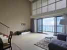 Modern living room with large windows and sea view