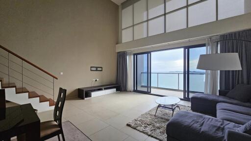 Modern living room with large windows and sea view