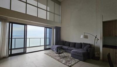 Living room with large floor-to-ceiling windows and ocean view