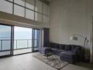 Living room with large floor-to-ceiling windows and ocean view