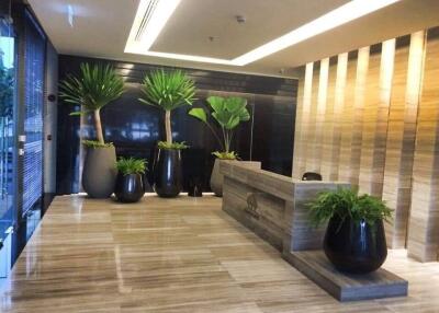 Luxury building lobby with modern decor and greenery