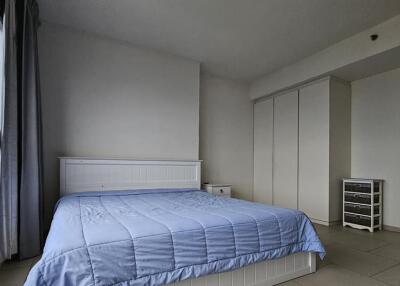 Modern bedroom with large window and blue bedding