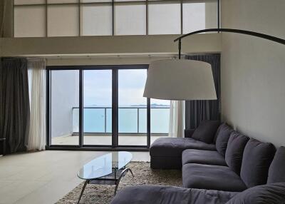 Modern living room with large windows and ocean view