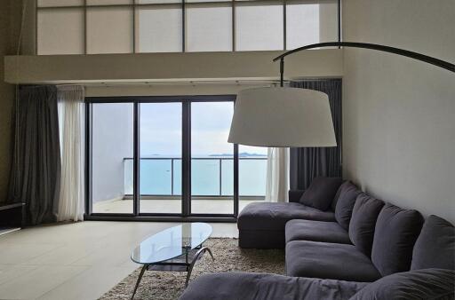 Modern living room with large windows and ocean view