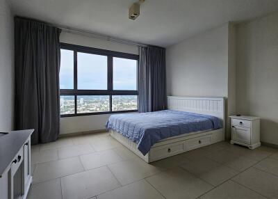 Bedroom with large window and city view