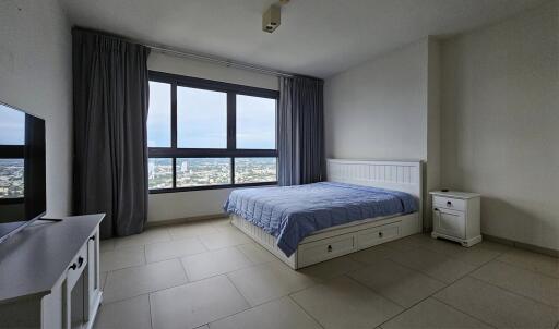 Bedroom with large window and city view