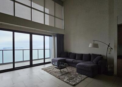 Spacious living room with large windows and ocean view