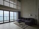 Spacious living room with large windows and ocean view