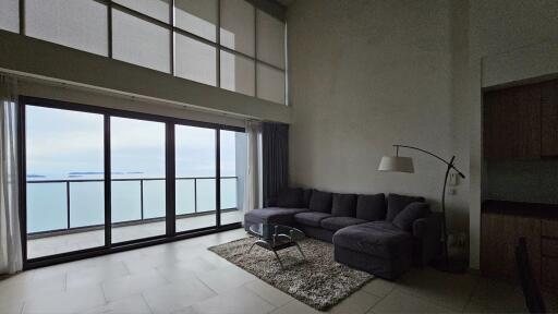 Spacious living room with large windows and ocean view