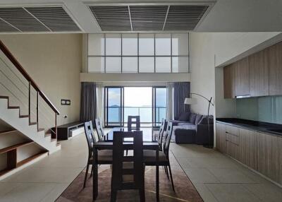 modern dining space with loft and large windows