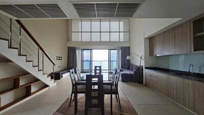 modern dining space with loft and large windows